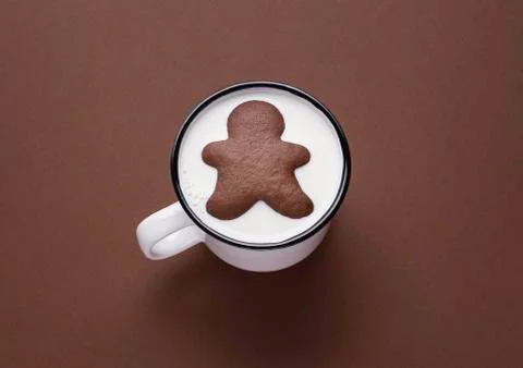 Gingerbread man inside milk cup. Milk and cookies. Xmas sweets Stock Photos