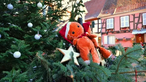 Gingerbread Man Ornament on Christmas Tree with traditional half timbered houses Stock Footage 346845433