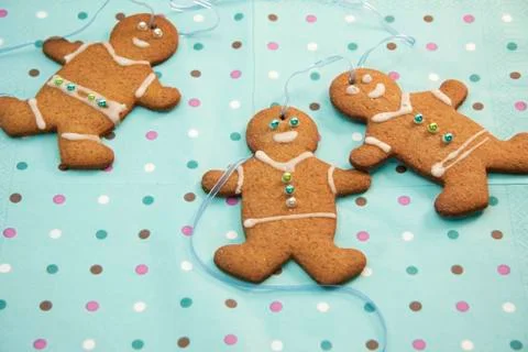 Gingerbread men on spotted background Stock Photos