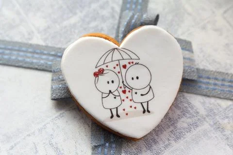 Gingerbread in the shape of a heart with a funny pattern Stock Photos