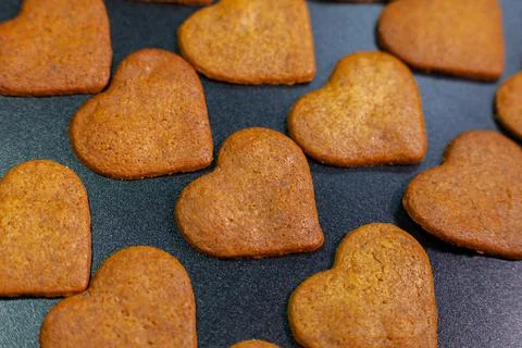 Gingerbread shaped hearts on the table. Stock Photos