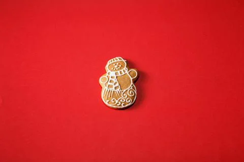 Gingerbread snowman on a red background. The basis for the design of the post Stock Photos