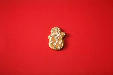Gingerbread snowman on a red background. The basis for the design of the post Stock Photos