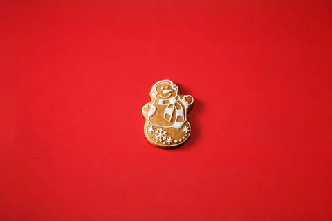 Gingerbread snowman on a red background. The basis for the design of the post Stock Photos