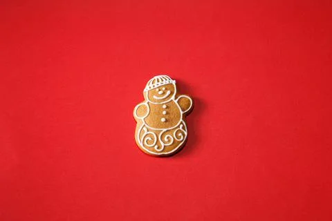 Gingerbread snowman on a red background. The basis for the design of the post Stock Photos