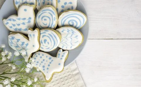Gingerbread in sugar glaze, in the form of eggs and rabbits, on a light wooden Stock Photos