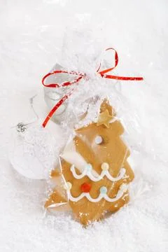 Gingerbread tree cookie in a bag on white  snow background Stock Photos