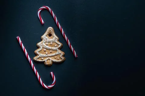 A gingerbread tree sits on top of two red and white candy cane sticks. Chri.. Stock Photos