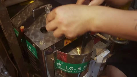 Ginseng being fed into a chopper at a dried food store,4K Video stock 282965354