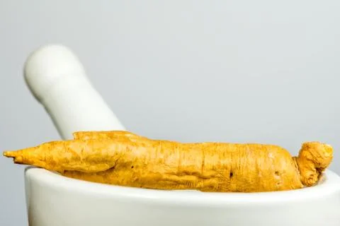 Ginseng root on a mortar Stock Photos