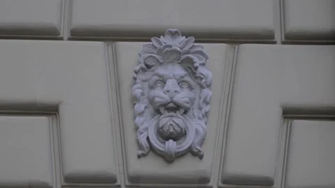 Gipsum lion on the wall of an old house Stock Footage