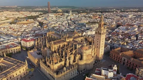 Giralda bell tower rising over Cathedral of Seville, Spain aerial view Stock Footage 341755464