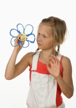 Girl (10-11) painting flower with fingerpaint, portrait Stock Photos