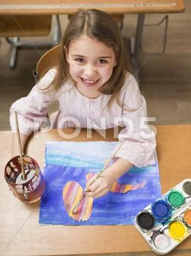 Girl (4-7) painting, smiling, elevated view, portrait Stock Photos