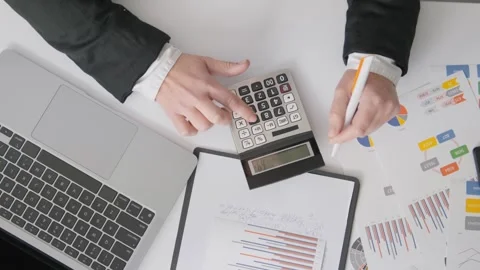 A girl accountant is focused on compiling financial reports and manages the Stock Footage 260562653