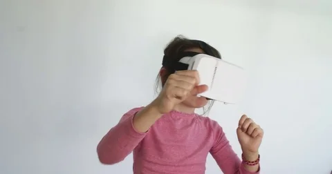 Girl acting out augmented world with VR headset. Stock Footage 80068942