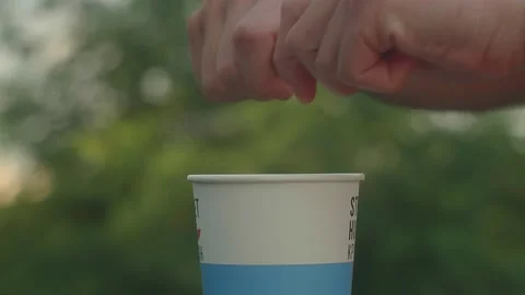 Girl Adding Sugar in a Cup of Coffee in Famous Kyiv Park Stock Footage 136040113