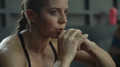The girl after a workout wipes the sweat from face. rest after training Stock Footage