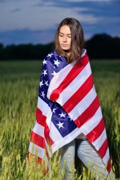 Girl with the American flag on his shoulders. 4th july - Independence Day Stock Photos