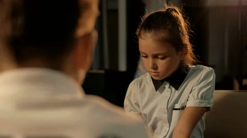 Girl and boy are playing chess. A young cute girl makes a move in a chess board. Stock-Footage 156700618
