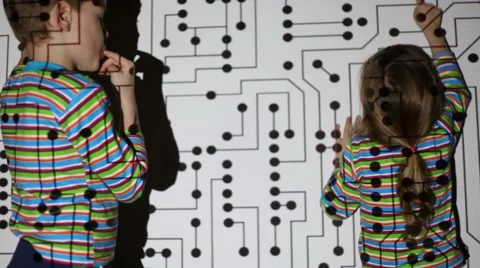 Girl and boy with a chocolate-smeared mouth lead their fingers on a wall Stock Footage