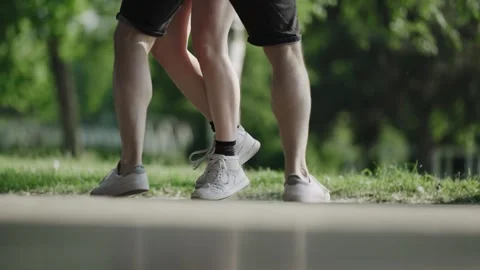 Girl and boy dancing on the dance floor in park, cinematic selective focus fo Stock Footage 330109434
