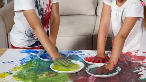Girl and boy smear their shirts in the paint Stock Footage