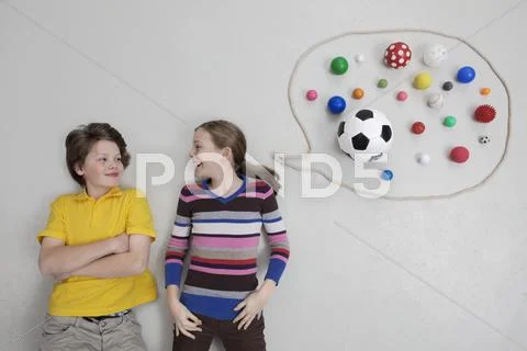 Girl and boy with speech bubble, smiling Stock Photos