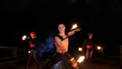 Girl and guy dancing with fire in the dark Stock Footage 71540279