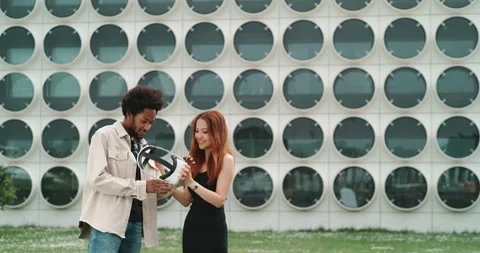 A girl and a guy experimenting virtual reality in the city center Stock Footage 201114512