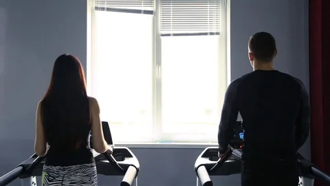 Girl and guy on the treadmill Stock Footage
