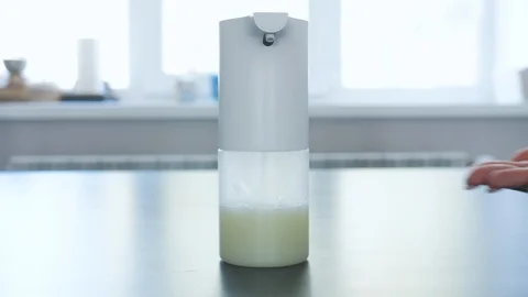 Girl and man using automatic foam soap dispenser, washing hands, close, macro Stock Footage 129333697