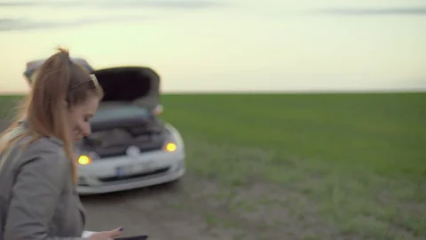 The girl appears in the video frame , with a soiled face,A car with yellow Video stock 129785161