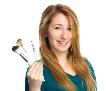Girl is applying makeup  using brush Stock Photos
