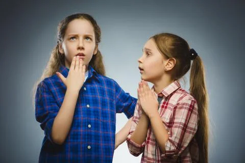 The girl asks for something from another thoughtful girl. Communication concept Stock Photos