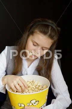 Girl asleep in a movie theater Stock Photos