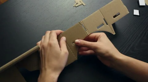 Girl assembling a Virtual Reality cardboard glasses Stock Footage 66607932