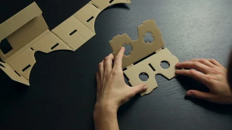 Girl assembling a Virtual Reality cardboard glasses Stock Footage 66626898