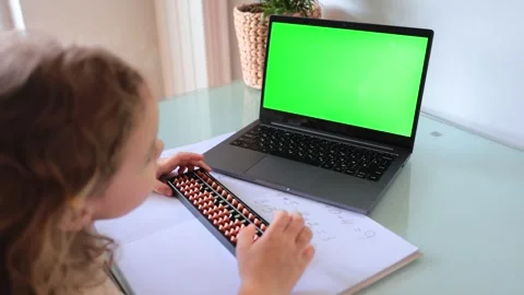 A girl from the back is engaged in mental arithmetic on the abacus online on a l Stock Footage 240925092