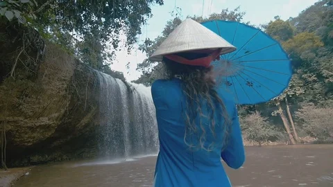 Girl on the background of a small waterfall Stock Footage 73566327