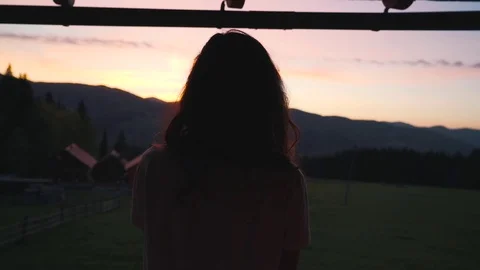 Girl on the background of sunset in mountains Stock Footage 76248909
