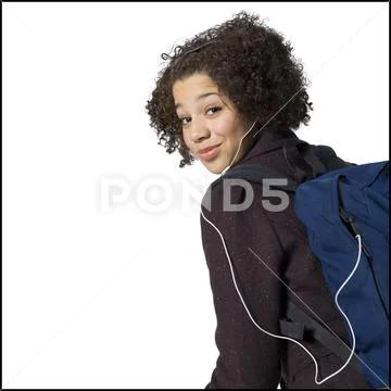 Girl with backpack and earbuds smiling with braces Stock Photos
