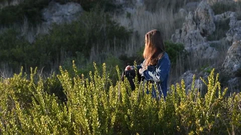 A girl with backpack opening a reusable bottle and drinks water Stock Footage 131556482