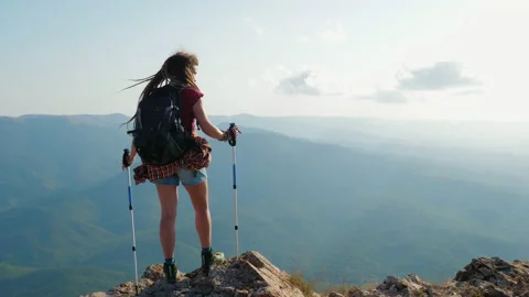 Girl with backpack stands on mountain Video stock 228677353