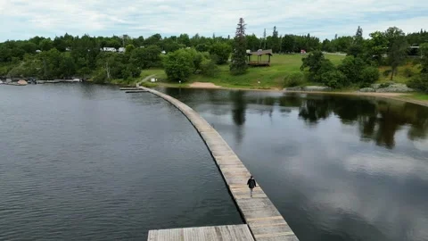 Girl with backpack walking on the bridge 動画素材 320285422