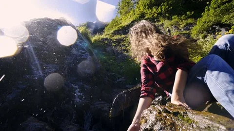 Girl backpacker splashes in waterfall Stock-Footage 123850991