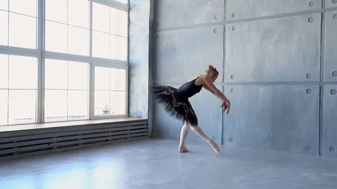 The girl the ballerina dances before a panoramic window. The beautiful refined Stock Footage