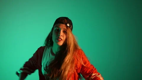 Girl in a baseball cap dancing hip hop on a green background,isolated Stock-Footage 107496228