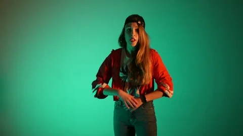 Girl in a baseball cap dancing hip hop on a green background,isolated Stock-Footage 107496296