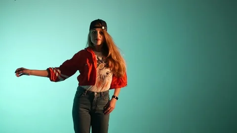 Girl in a baseball cap dancing hip hop on a green background,isolated Stock Footage 107496324